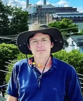 Tillman Kiesow wearing a broad-brim hat on a rooftop
